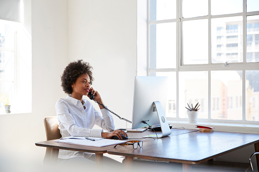 Woman working from home using FTC Premium Wi-Fi Service