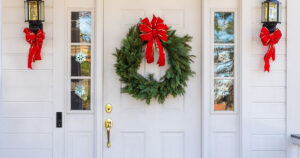 front door to a home with a holiday wreath